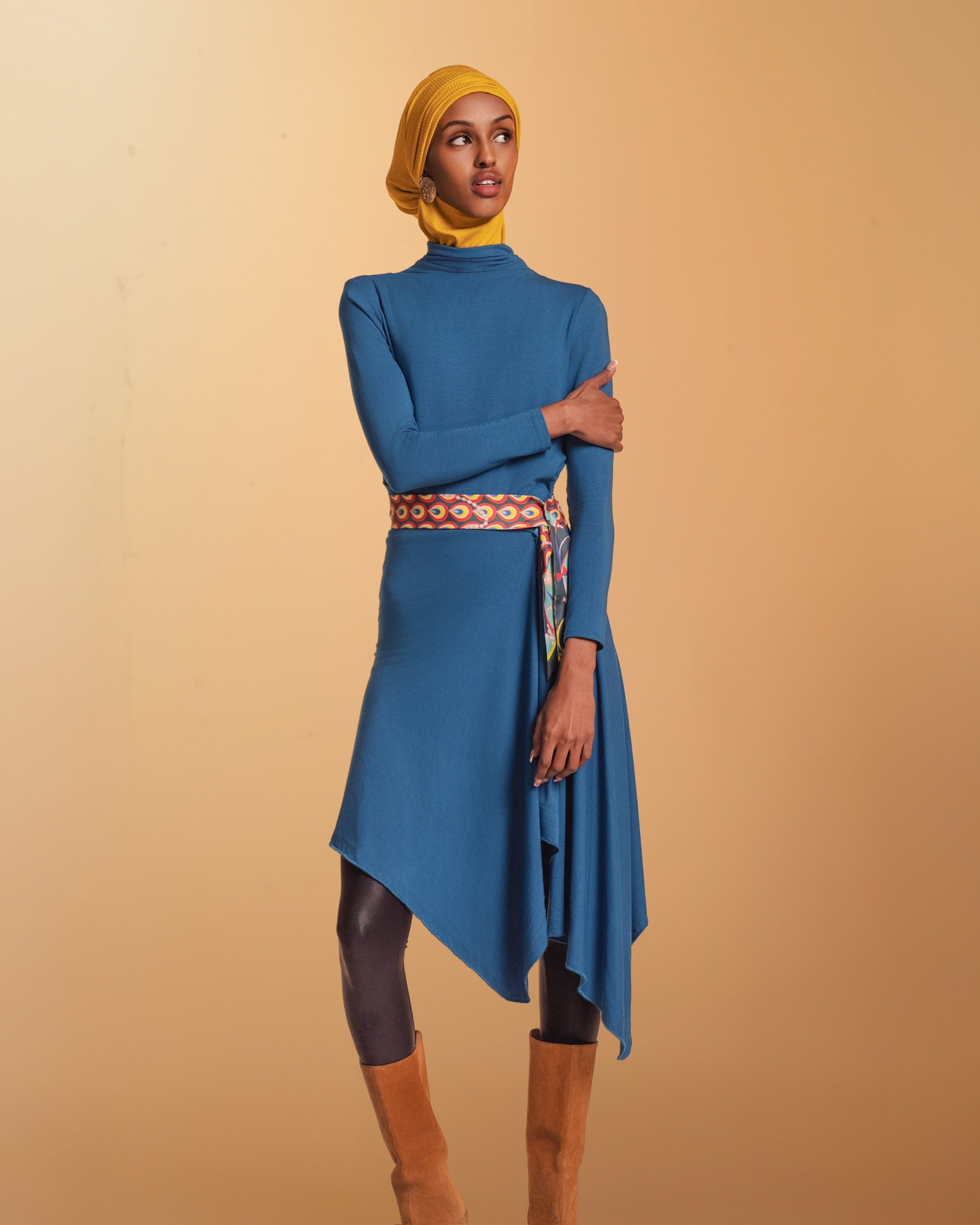 A Woman wears the Veil Bodysuit with the overlay extended becoming a tunic.