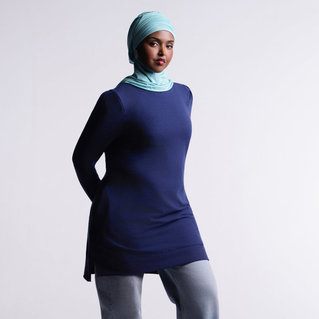 Revive Fleece Pullover front view, puff shoulders and split hem, worn with a turquoise hijab, light-wash jeans and sneakers