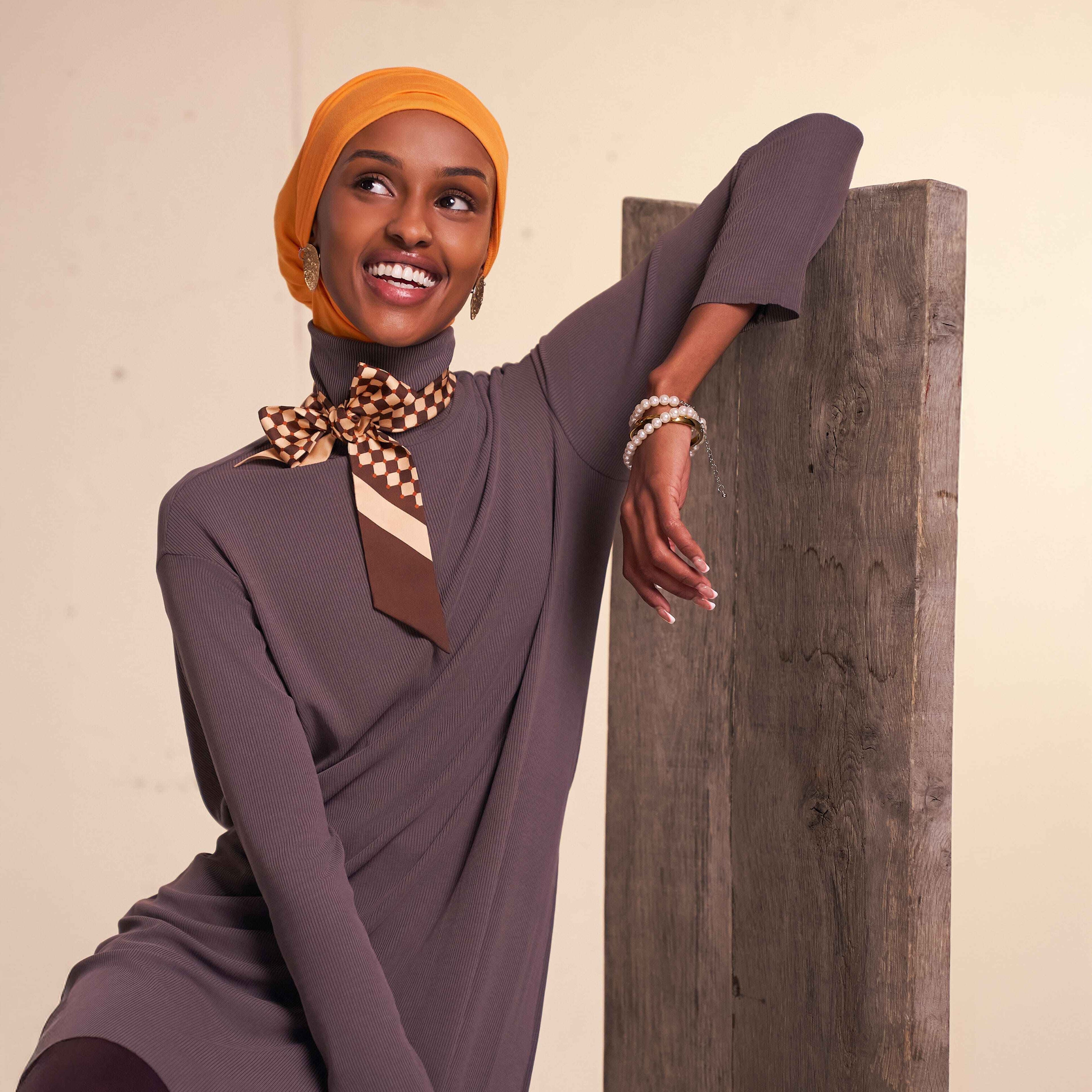 Woman wearing modest flow tunic and 2-in-1 slip-on hijab set in a modern neutral tone