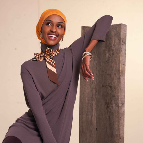 Woman wearing modest flow tunic and 2-in-1 slip-on hijab set in a modern neutral tone