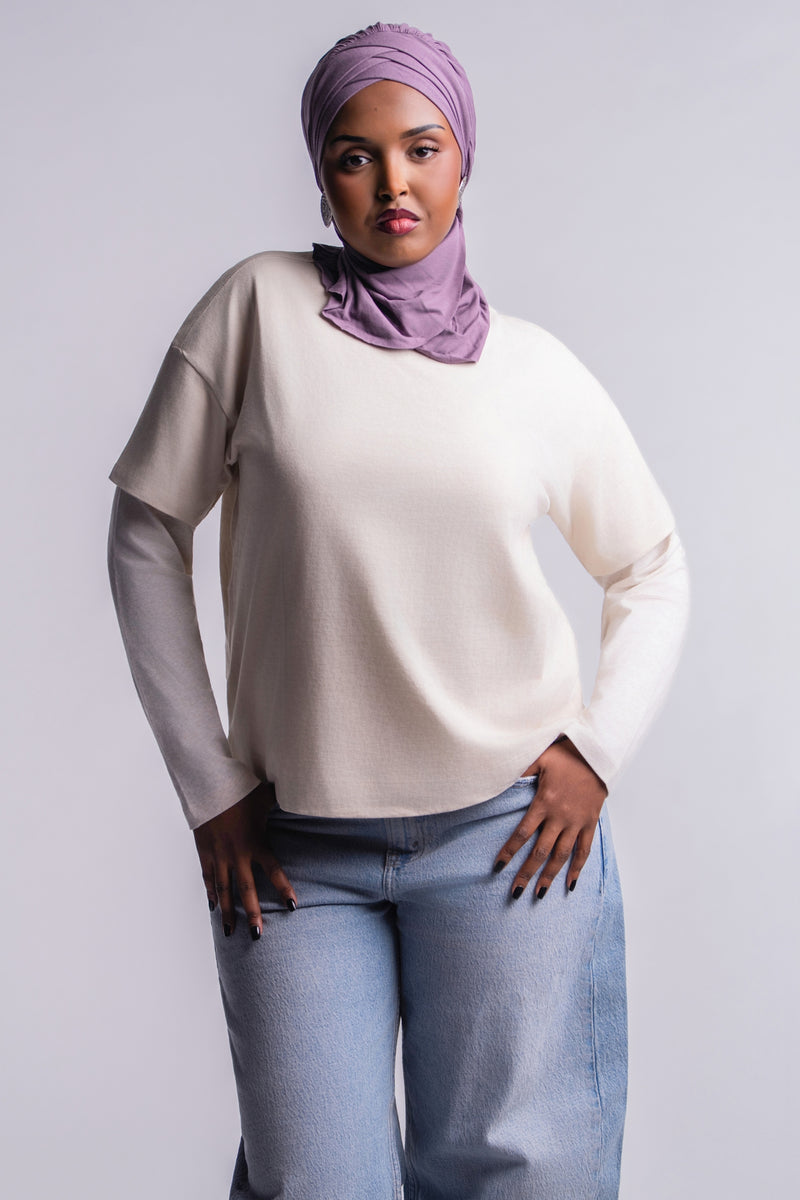 DuoSnap Hijab in a dusty lavender, front view with pleated crown and neck coverage, worn with a cream layered tee and light-wash jeans