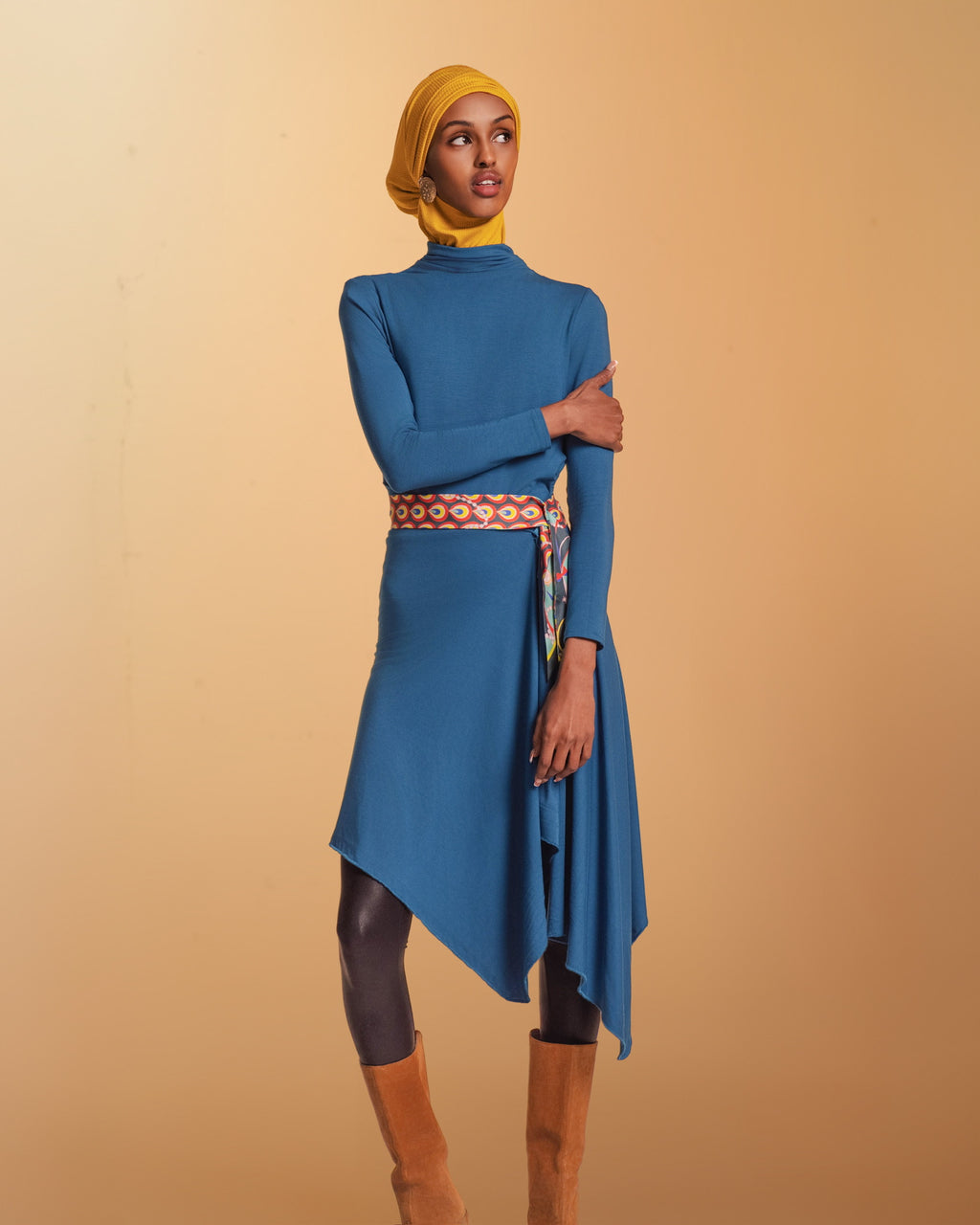 A Woman wears the Veil Bodysuit with the overlay extended becoming a tunic.